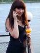 The girl in hands talks to a cocktail by a phone