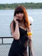 The girl with a cocktail speaks to mobile phone