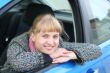 Blonde girl in a blue car