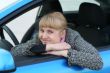 Blonde girl in a blue car