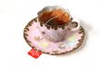 Antique cup with tea bag.