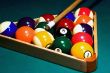 Racked pool balls, and a cue stick