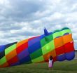 Girl Examines Colorful Wind Sock Kite