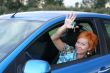 Young woman in a car with key