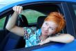 Young woman in a car with key