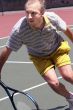Middleage man playing tennis