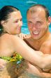 An attractive couple relaxing by the pool