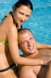 An attractive couple relaxing by the pool