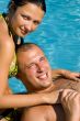 An attractive couple relaxing by the pool
