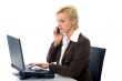 business blond woman speaks on the phone, isolated on white