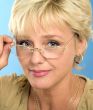 blonde adult businesswoman holding glasses and looking through
