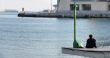 The man sitting on a pier