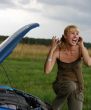 young woman with her broken car