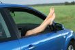 Womans legs and a car