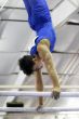 Young gymnast competing on parallel bars