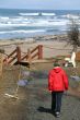 Red parka woman walking to beach