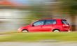 Fast moving red car