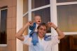 Adorable boy on his dad`s shoulders