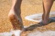 barefoot in surf on sand coast