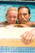 attractive couple relaxing by the pool