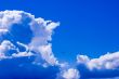 Tiny plane in vivid light cloudscape