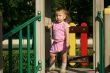 Babygirl in sunset lights on playground