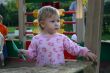Toddler with shovel in sandbox
