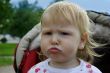 Unhappy child in pram