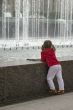 Thoughtful child near fountain