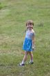 Smiling little cutie standing on the grass