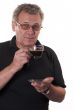 Serious man in glasses drinking coffee