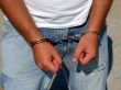 Hands of the man, chained in handcuffs