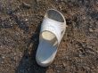 The lost white sandal laying on the beach