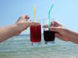 Two man`s hands with glasses of cocktails