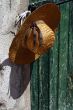 Stylish straw hat on the wall