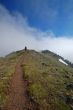 Man hiking on a trail in the mountains