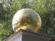 a golden sphere on the column