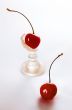 Two cherries on a white background