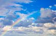 rainbow in the sky between the clouds