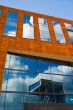 office building windows reflecting clouds