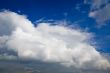 big white clouds approaching in a blue sky