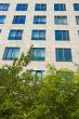 office building with green foliage in front