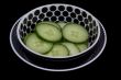 Sliced cucumber in bowl.