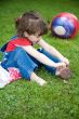 The little girl in park, with the big ball