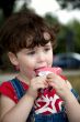 little girl is eating strawberry ice-cream