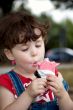 little girl is eating strawberry ice-cream