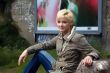 beautiful blonde woman poses on the street
