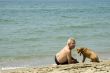 man with dog on the beach
