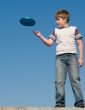 boy playing frisbee