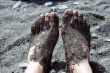 Feet in pebbles on the beach